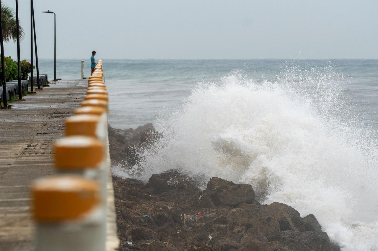 By midday, winds already howled in the capital, turning the sea into churning whitecaps as Beryl's eye scraped by the island's southern coast