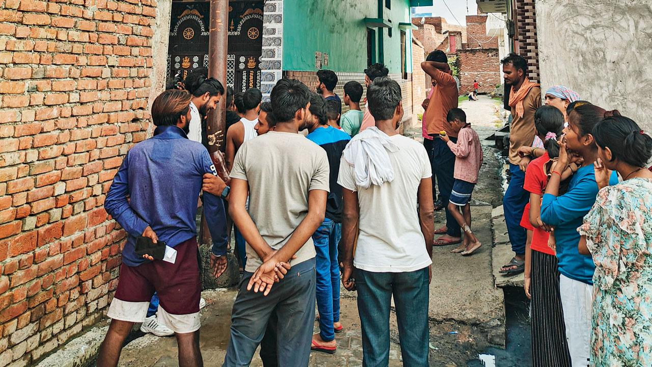 People gather near house of key accused Devprakash Madhukar