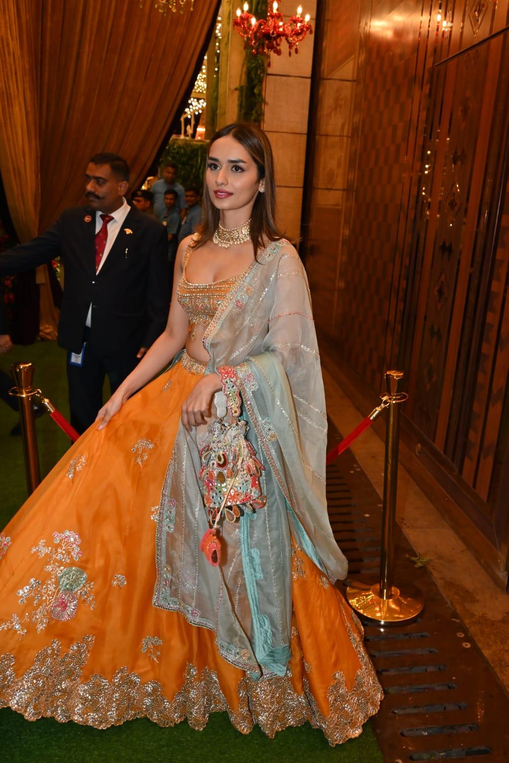 Manushi Chillar wore an orange lehenga and paired it with a green dupatta