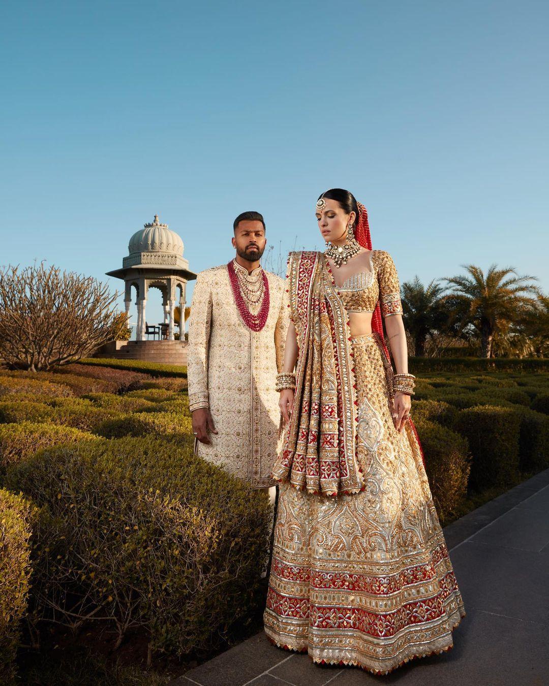 Natasa opted for a heavily embroidered lehenga with a red dupatta, while Hardik wore a beige-coloured sherwani