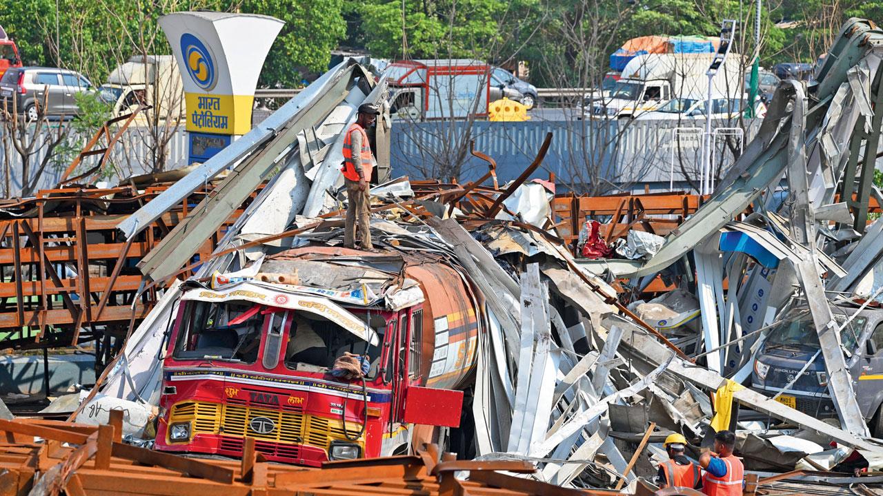 BMC and fire brigade teams clearing the site after the hoarding fell. File Pic/Atul Kamble