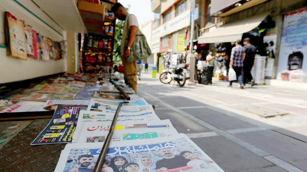 Newspaper headlines with election news on sale at a stall in Tehran on July 6, 2024, the day after the nation held presidential elections. Pics/PTI