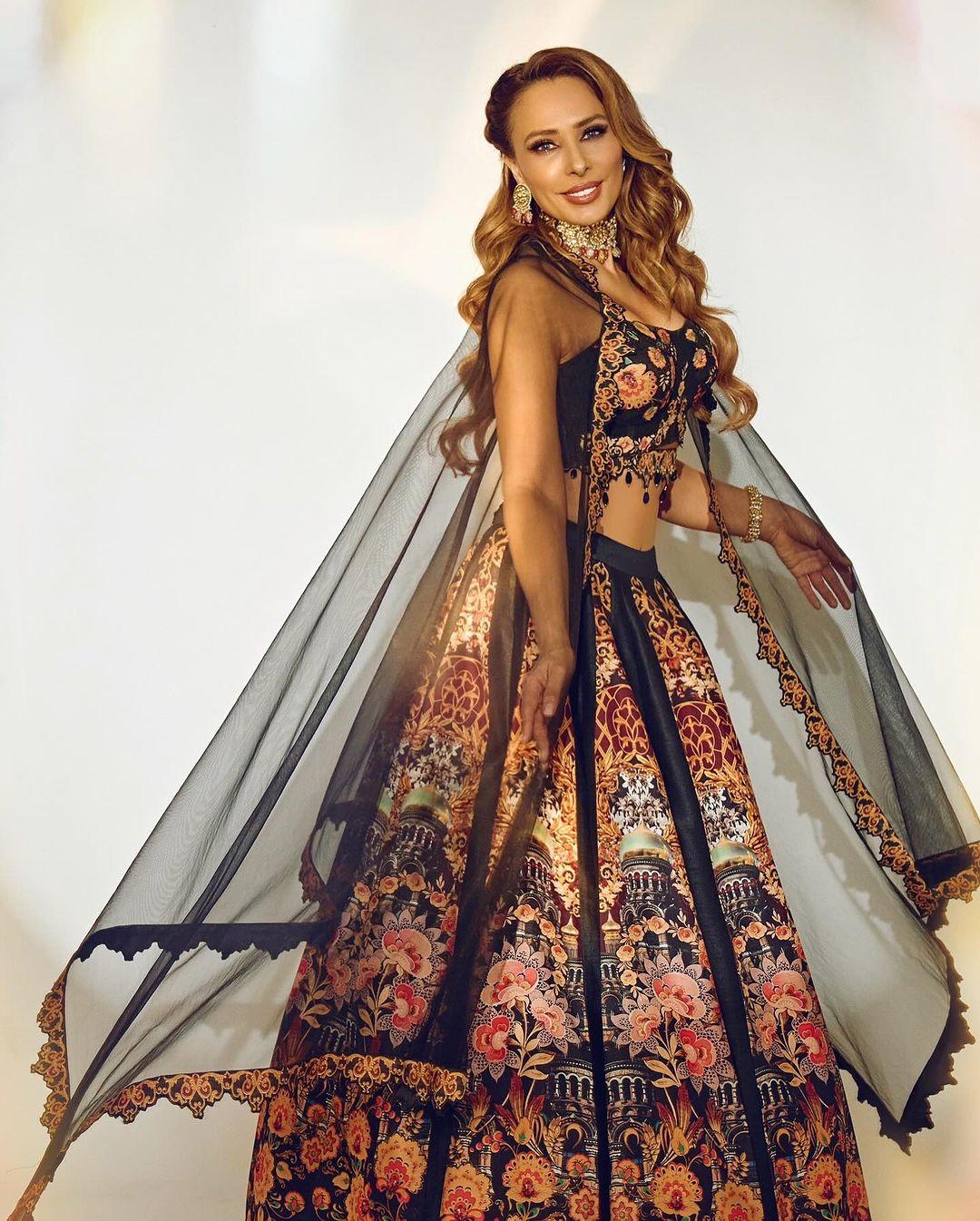 The blouse matched with similar flower embroidery, and the dupatta was styled like a cape.