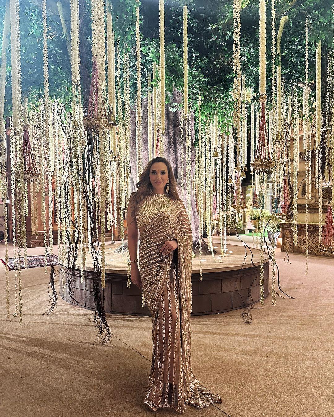 Iulia attended the Ambani wedding wearing a dazzling golden saree designed by Manish Malhotra. 