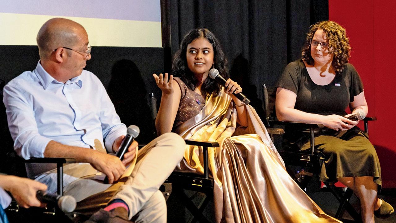 Saanika Kodial (centre) speaks at the premiere of the documentary