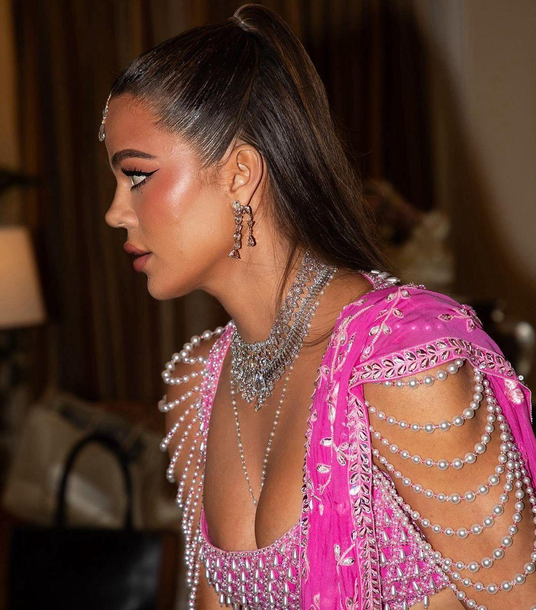 Khloe paired the lehenga choli with a matching dupatta and tied her hair in a half ponytail