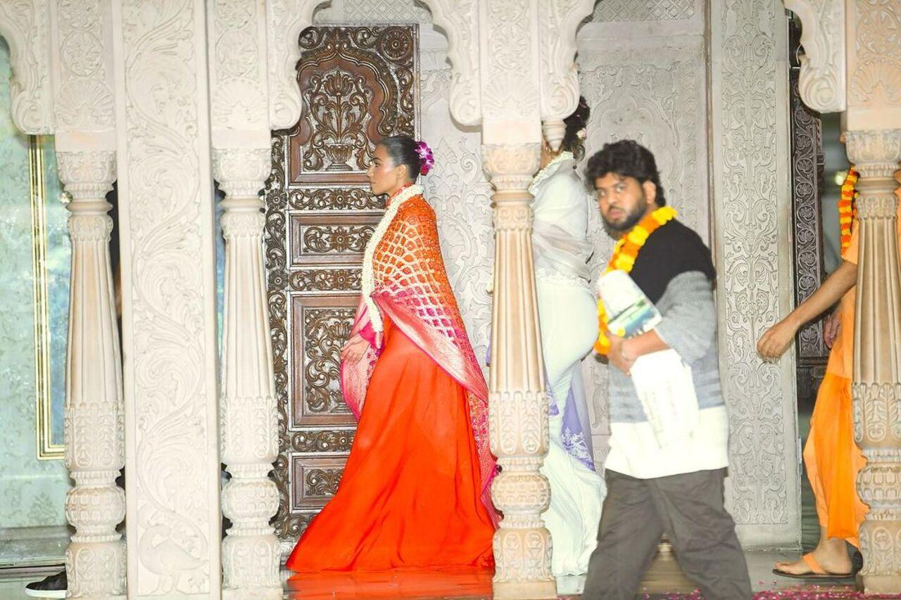 In this picture, Kim was seen walking inside the temple with garland around her neck