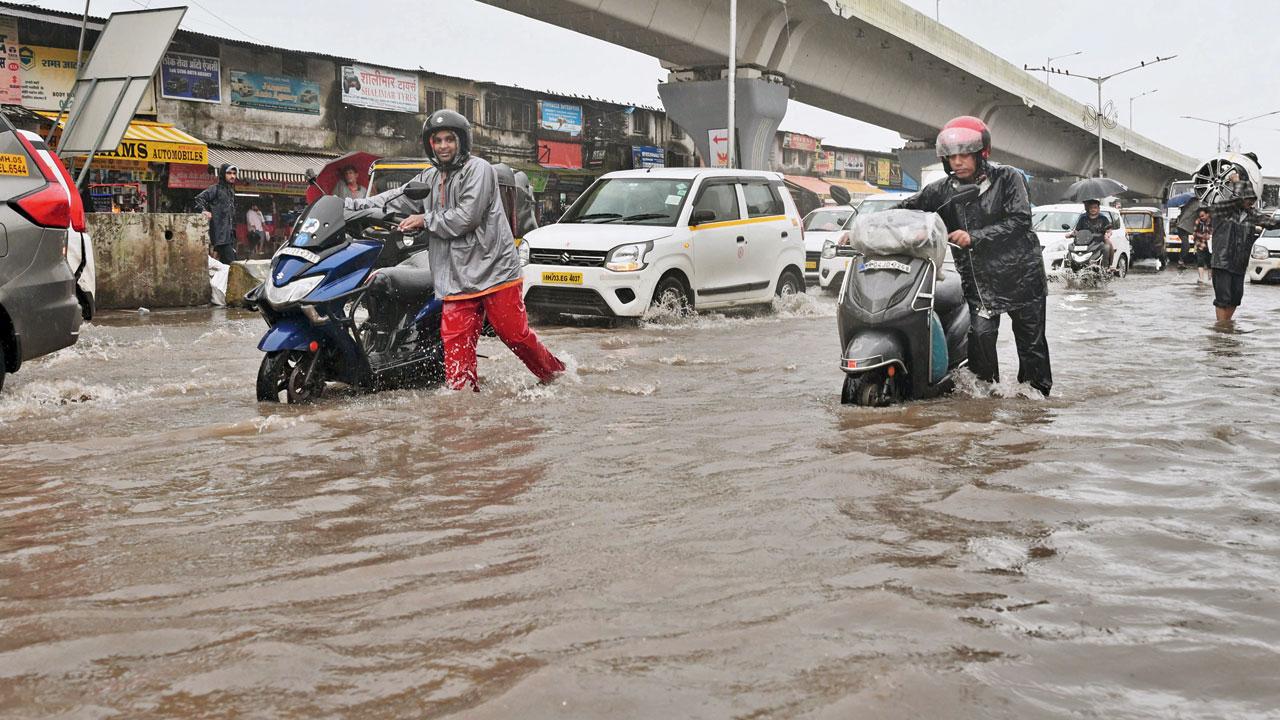 Waterlogged Kalina-Kurla Road damages vehicles. Pics/Sayyed Sameer Abedi