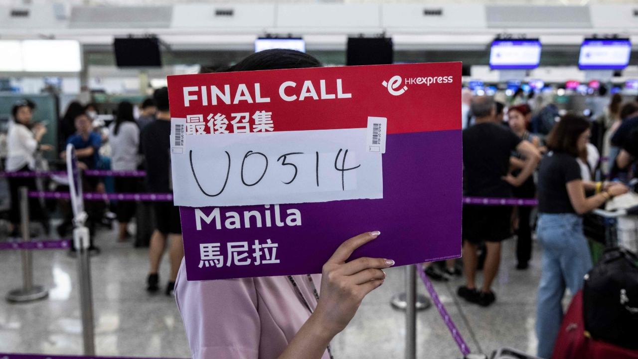 The airport staff had to hold up a final call sign at Hongkong International Airport as some airlines resort to manual check-in