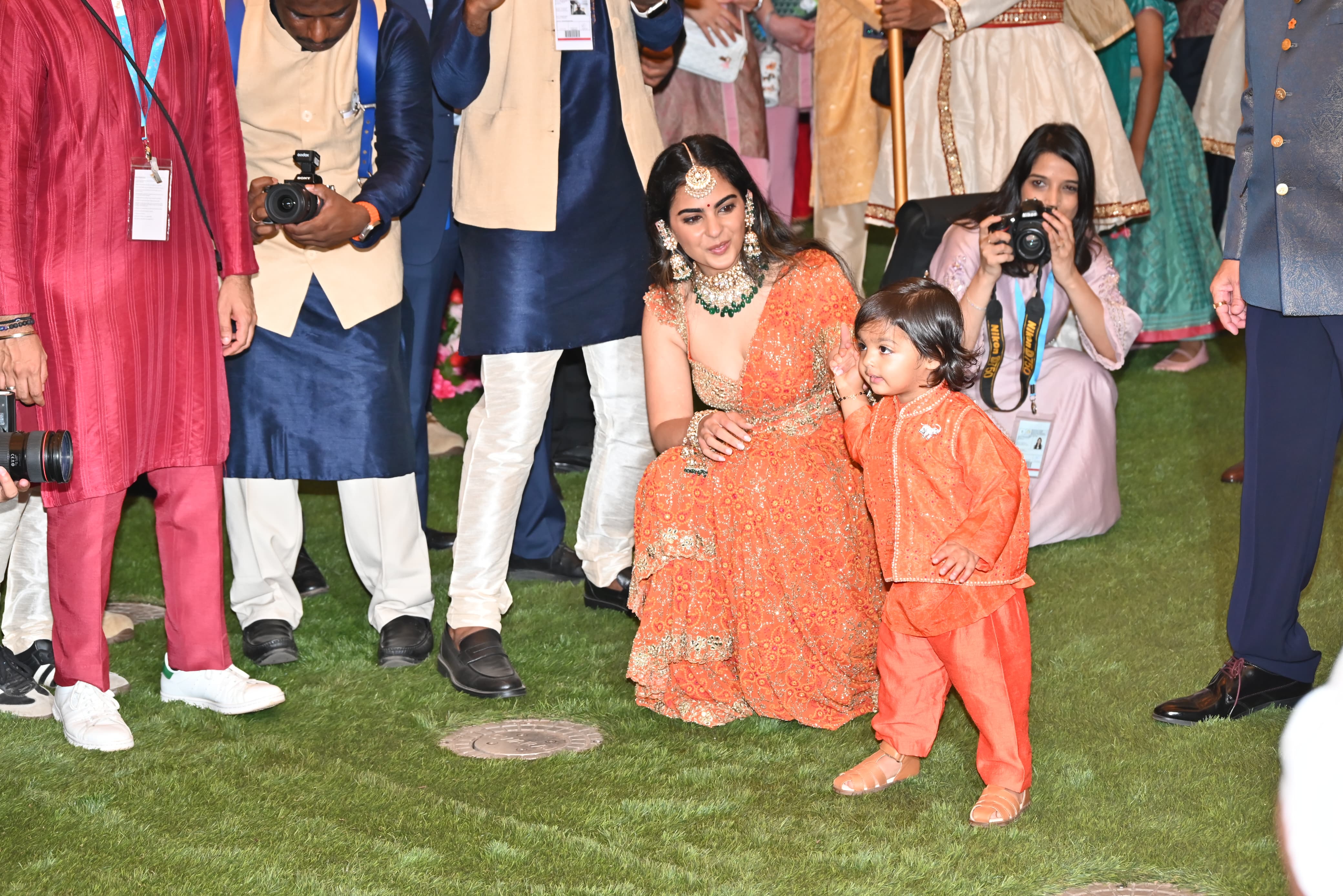Isha Ambani's heavily decorated orange lehenga, paired with contrasting green jewelry, stole our hearts