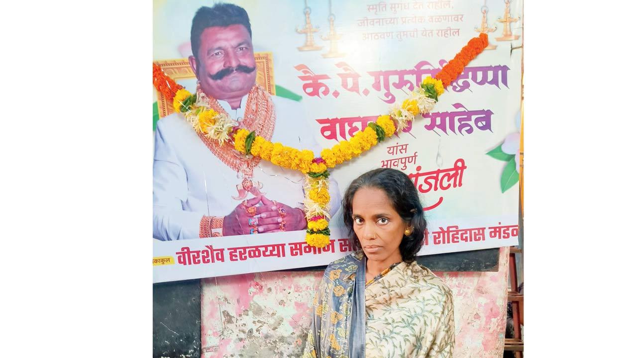 The deceased’s wife Manisha Waghmare in front of a poster of her husband