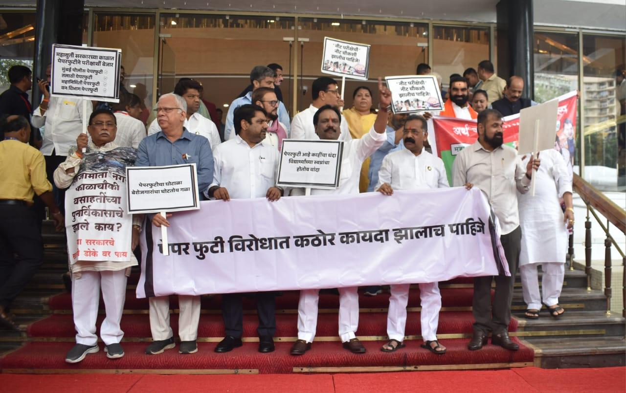 The opposition members, part of the Maha Vikas Aghadi (MVA) coalition consisting of the Shiv Sena (UBT), Congress and NCP (SP), holding placards, staged their protest on the stairs of the state legislature complex