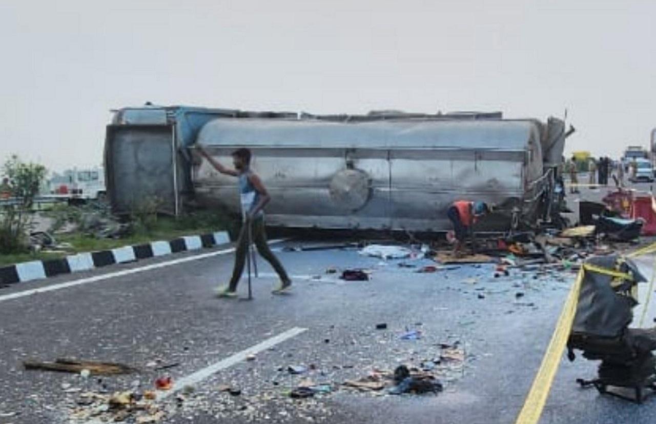 Glass shards and people's belongings lay scattered on the highway next to the overturned bus and milk tanker. Cranes were used to put the two vehicles back on their wheels and they were later towed away