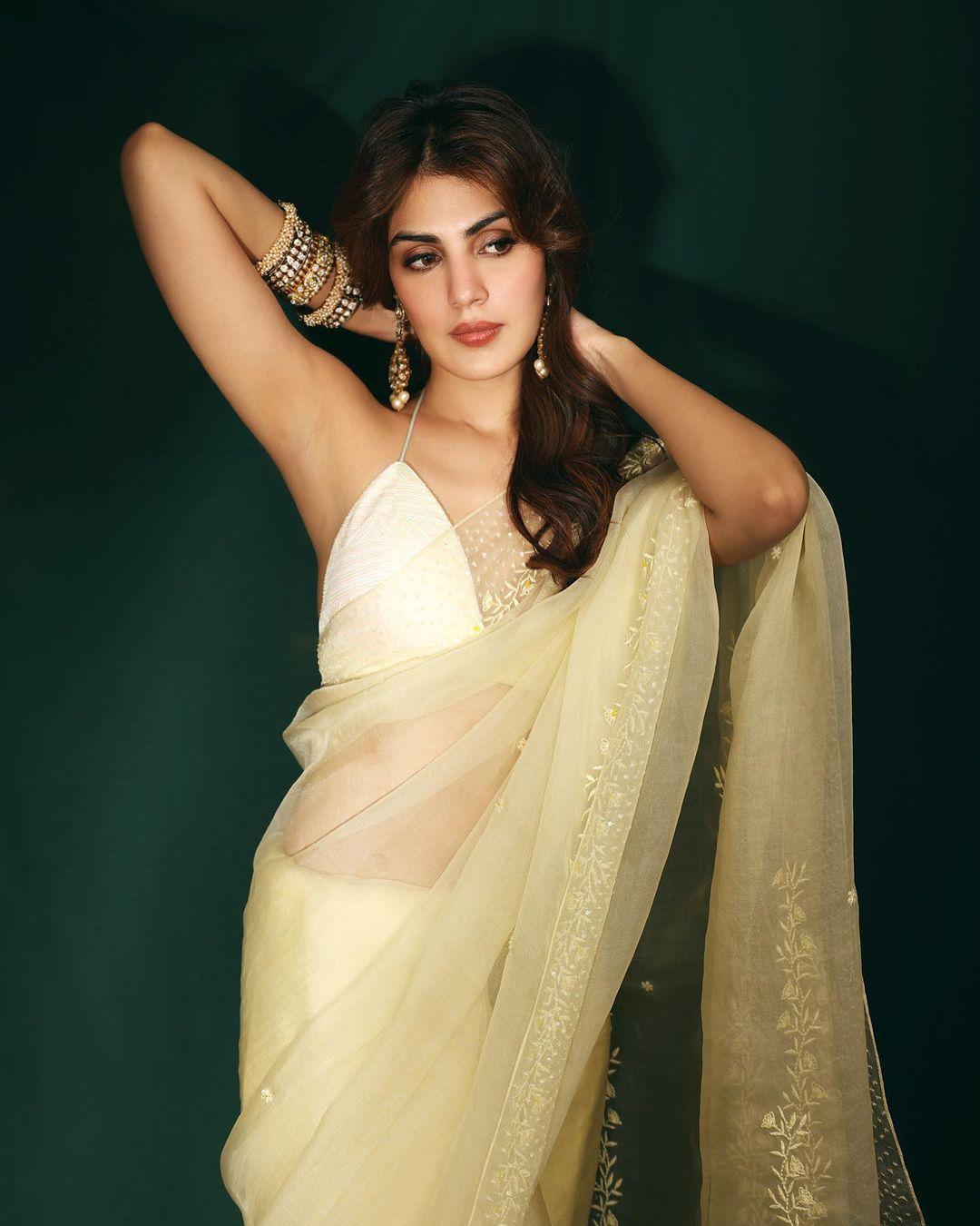 In this look, Rhea wore an off-white tissue saree with flowers embroidered on its border. The actress paired her saree with a halter-neck blouse