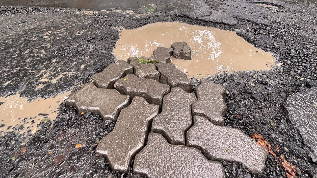 Potholes on the road outside Hallmark Business Plaza in Bandra East. Pic/Rane Ashish