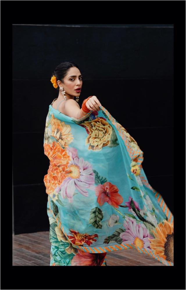 In a vibrant saree adorned with roses throughout, Sobhita Dhulipala embraces her lively personality with flair