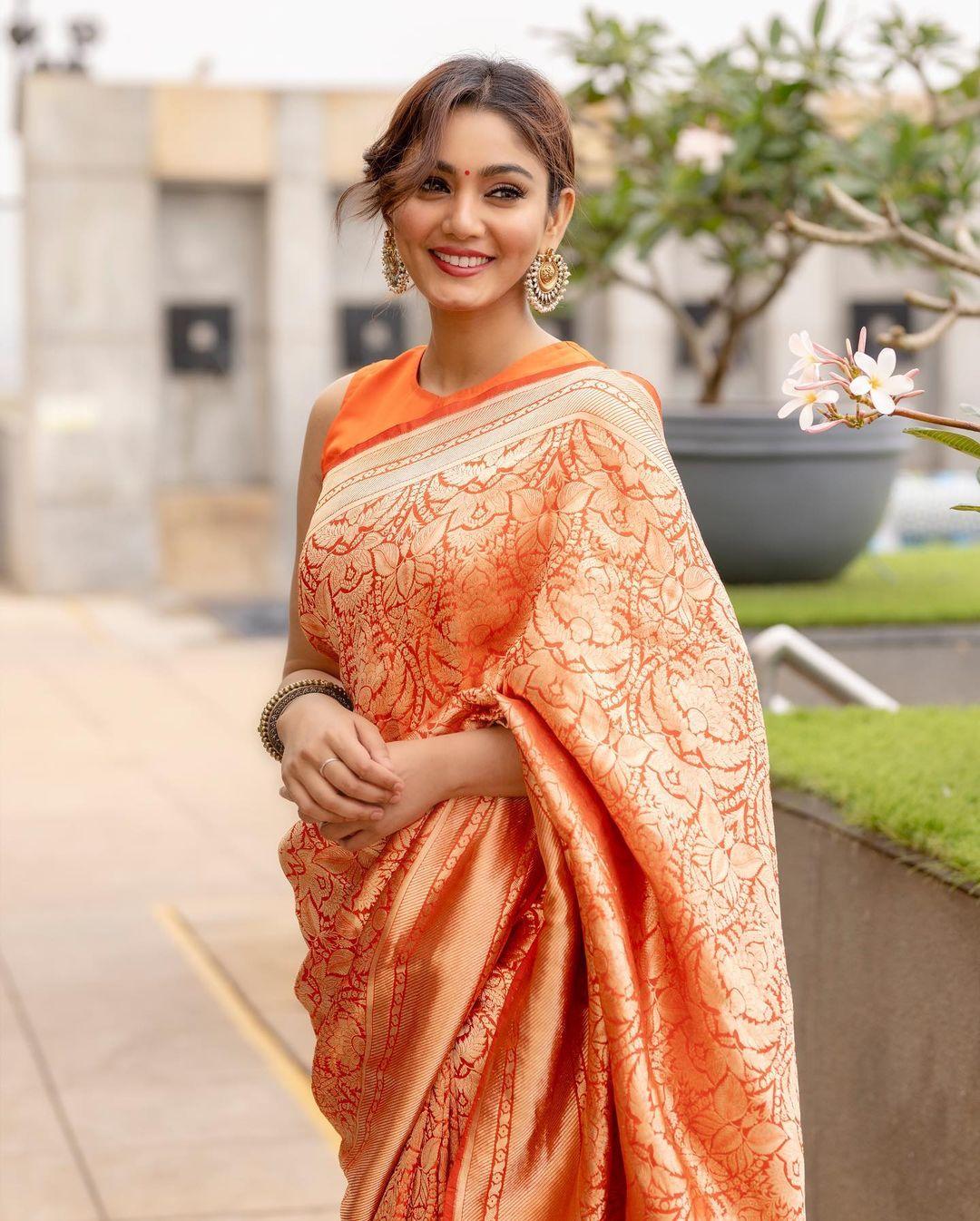 By tying her hair in a bun, she put on big chunky earrings. From puja to wedding functions, this saree is perfect for every occasion