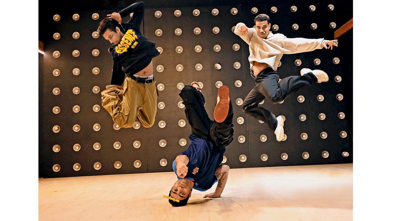(From left) Raman Kumar Dubey aka B-boy Fusion, Arif Chaudhary aka B-boy Flying Machine and Rajan Yadav aka B-boy Risk jam together at a dance studio in Andheri West. Pic/Satej Shinde