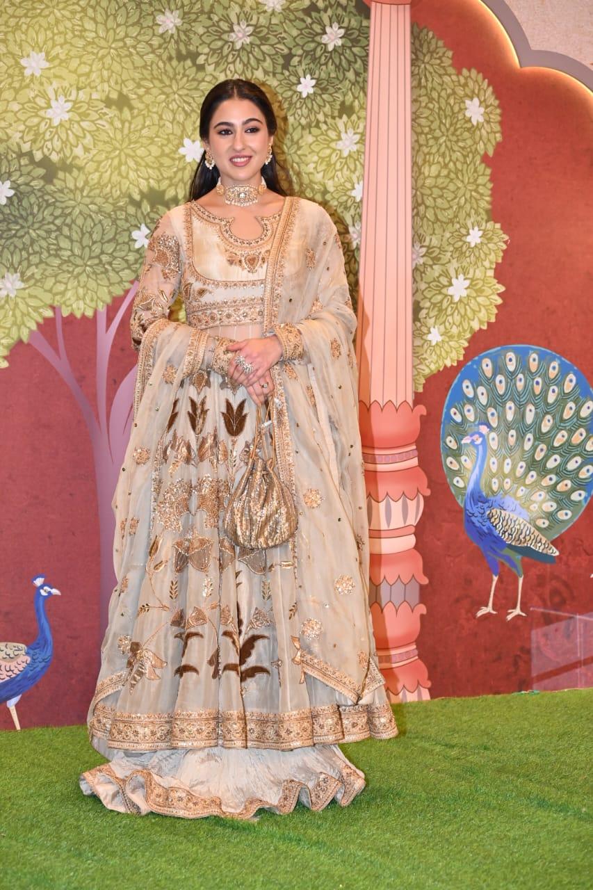 The actress's outfit was adorned with intricate gold and brown motifs. She accessorized her lehenga with an intricate choker and small earrings, pairing her outfit with a potli bag was a hit decision