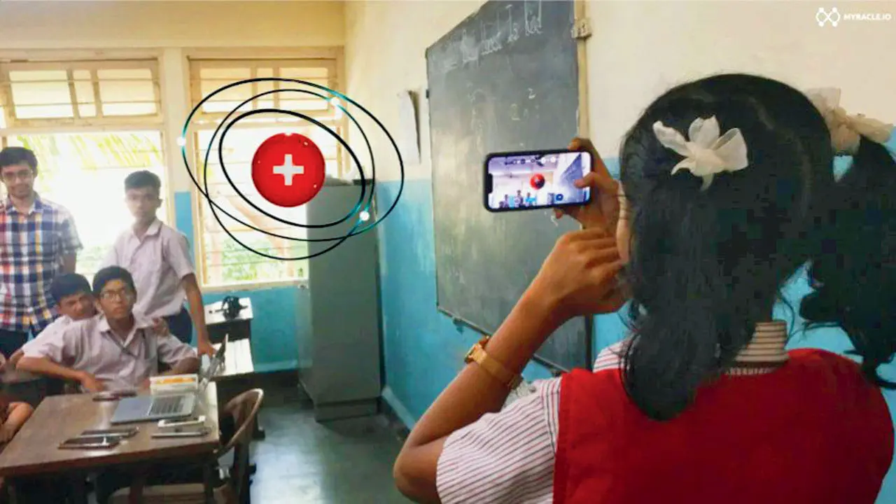 The view from the headset shows a 3D model of an atom, while a student looks at the same experience from her smartphone