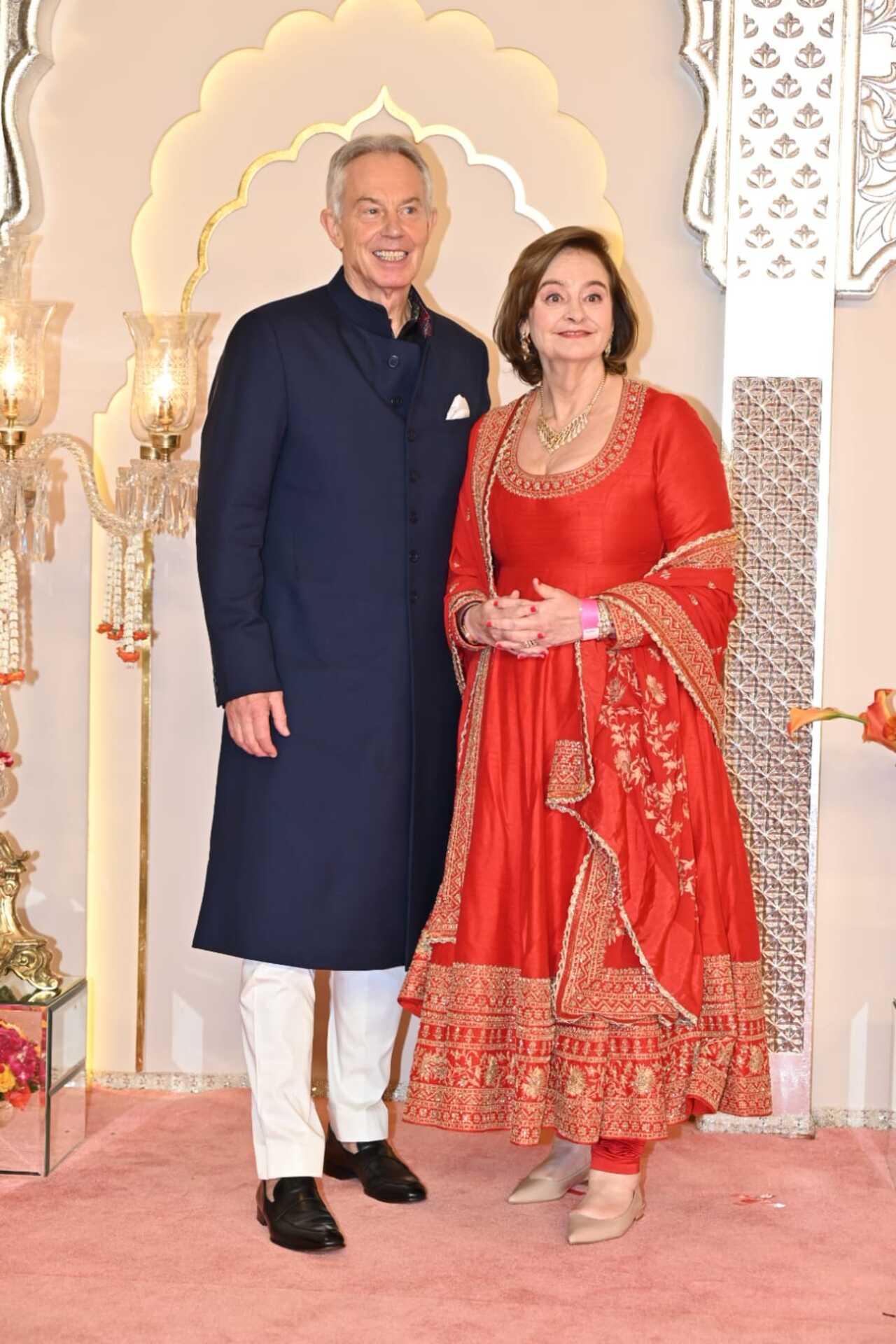 Seeing Tony Blair's wife in a suit was a pleasure. Cherie decoded the traditional outfit for herself and wore a simple red suit