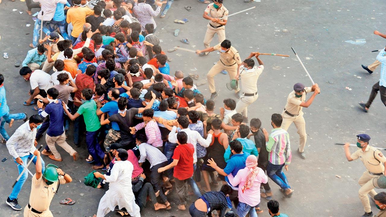 Police lathi-charge migrants gathered outside Bandra railway station, during the COVID-induced lockdown in  2020. Lathi charges will now be a thing of the past, with the retirement of the British-era IPC, says DGP Shukla. File pic/Rane Ashish