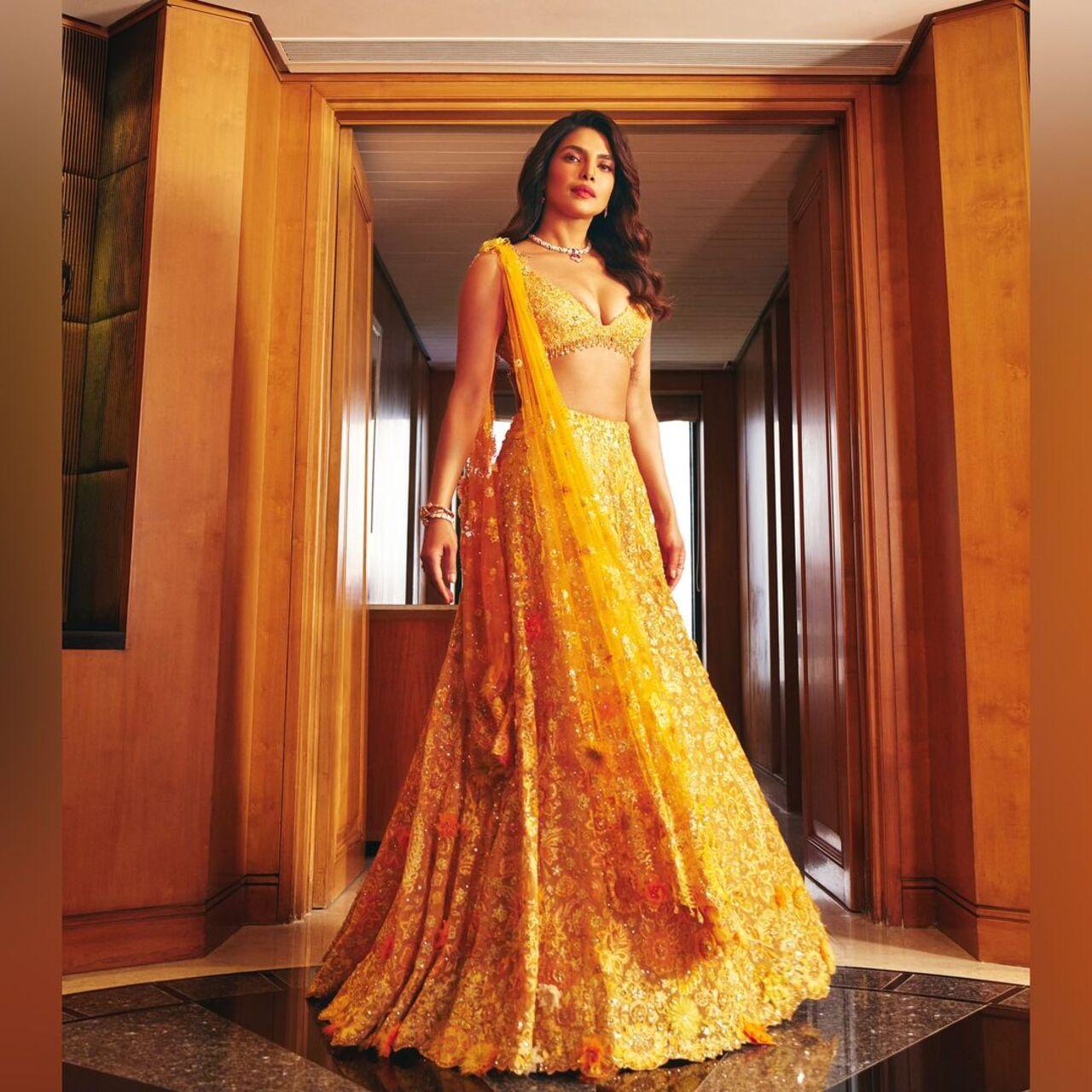 Priyanka stunned in a yellow lehenga paired with a deep V-neck strappy blouse and a stunning matching dupatta