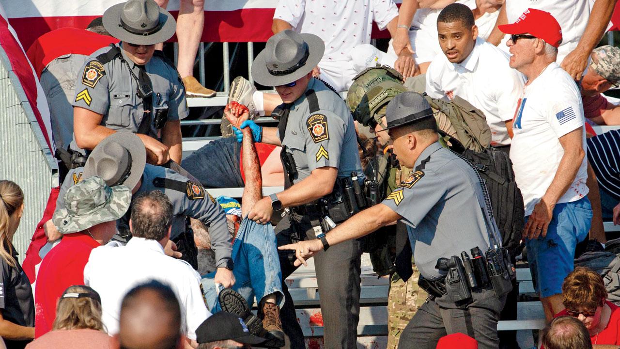 A person is removed by police from the stands after the firing incident in Butler, Pennsylvania. Pic/AFP