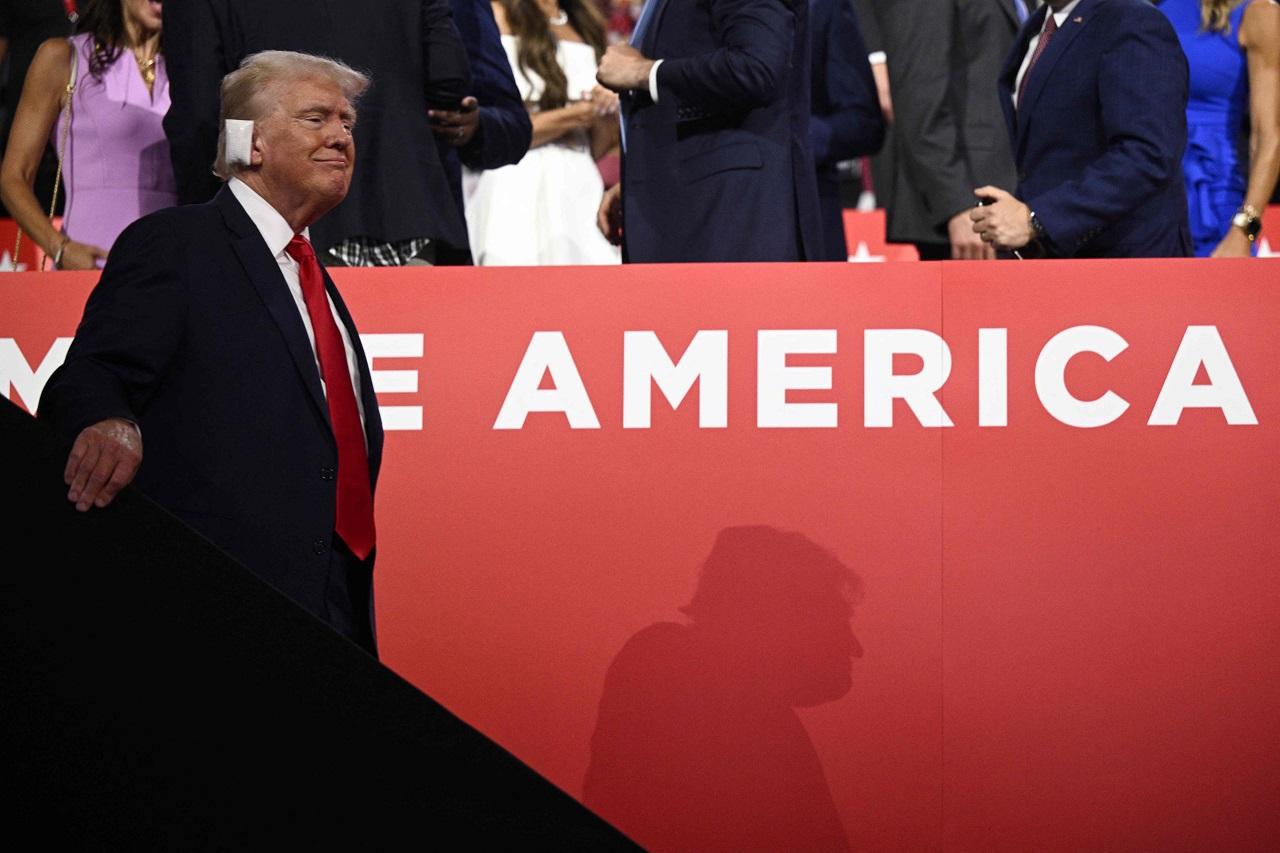 He applauded the officials and guests as they addressed the convention. During the convention, he sat next to JD Vance. During the convention, Trump's supporters carried posters that read, 