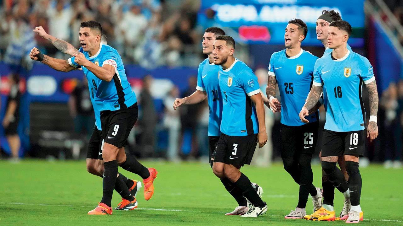 Uruguay players celebrate winning the penalty shootout against Canada in the third-place match at Charlotte on Saturday. Pic/AFP