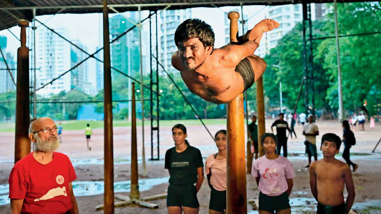 Venkatesh Mandadi performs Matsyasan on a pole mallakhamb