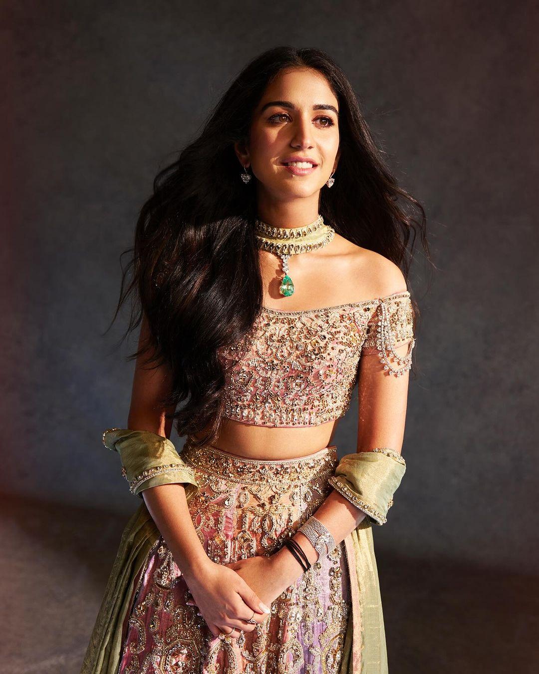 Though not an official Ambani, Radhika Merchant chose a first look featuring a light, multi-paneled tissue skirt in soft pastel colors, intricately hand-embroidered with Swarovski crystals.