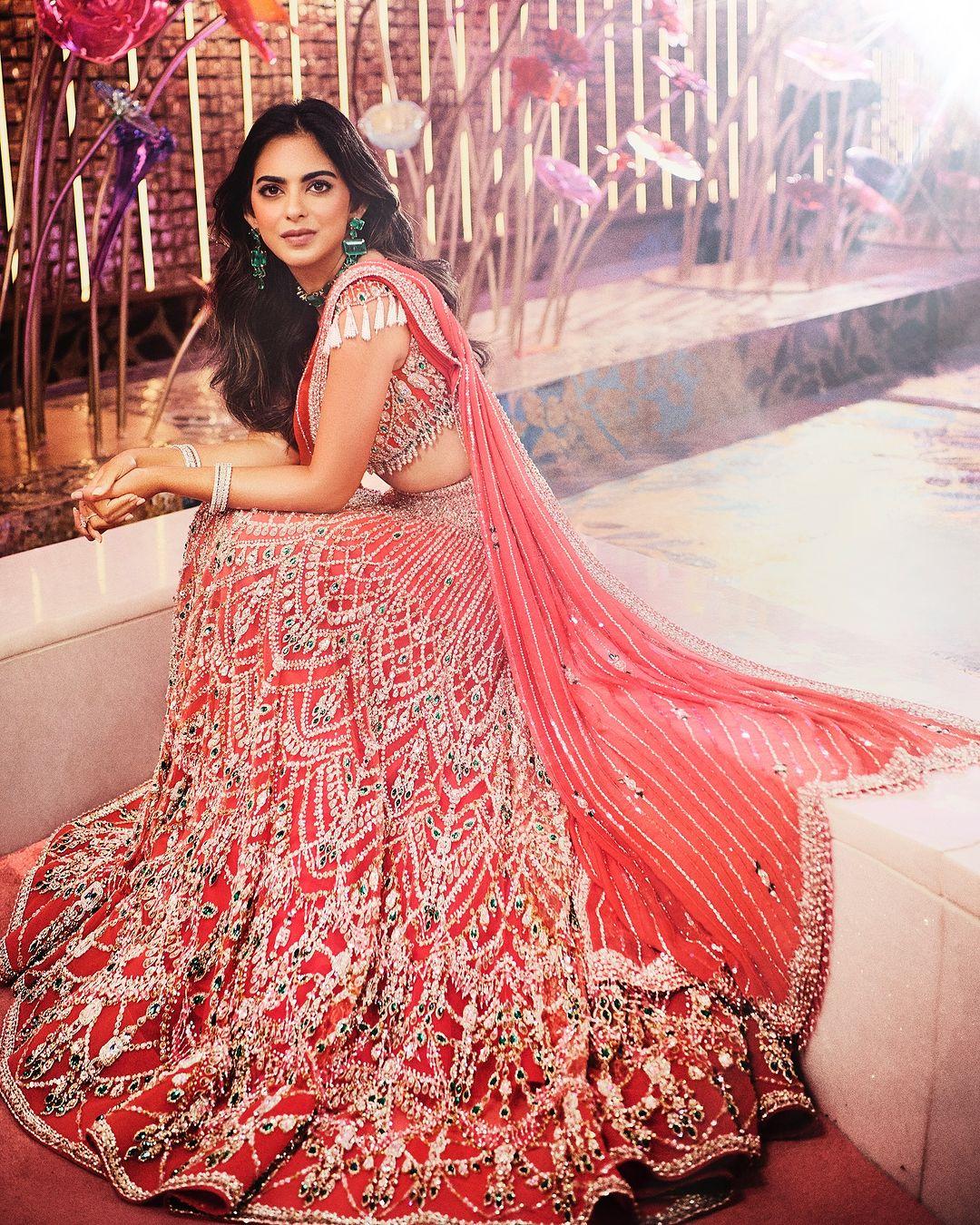 Isha looked stunning in a custom-made coral lehenga covered in more than 160,000 Swarovski crystals.
