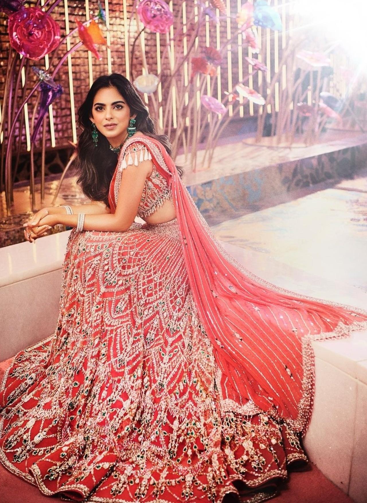 For her performance at the sangeet, she wore a coral Falguni and Shane Peacock lehenga. 
