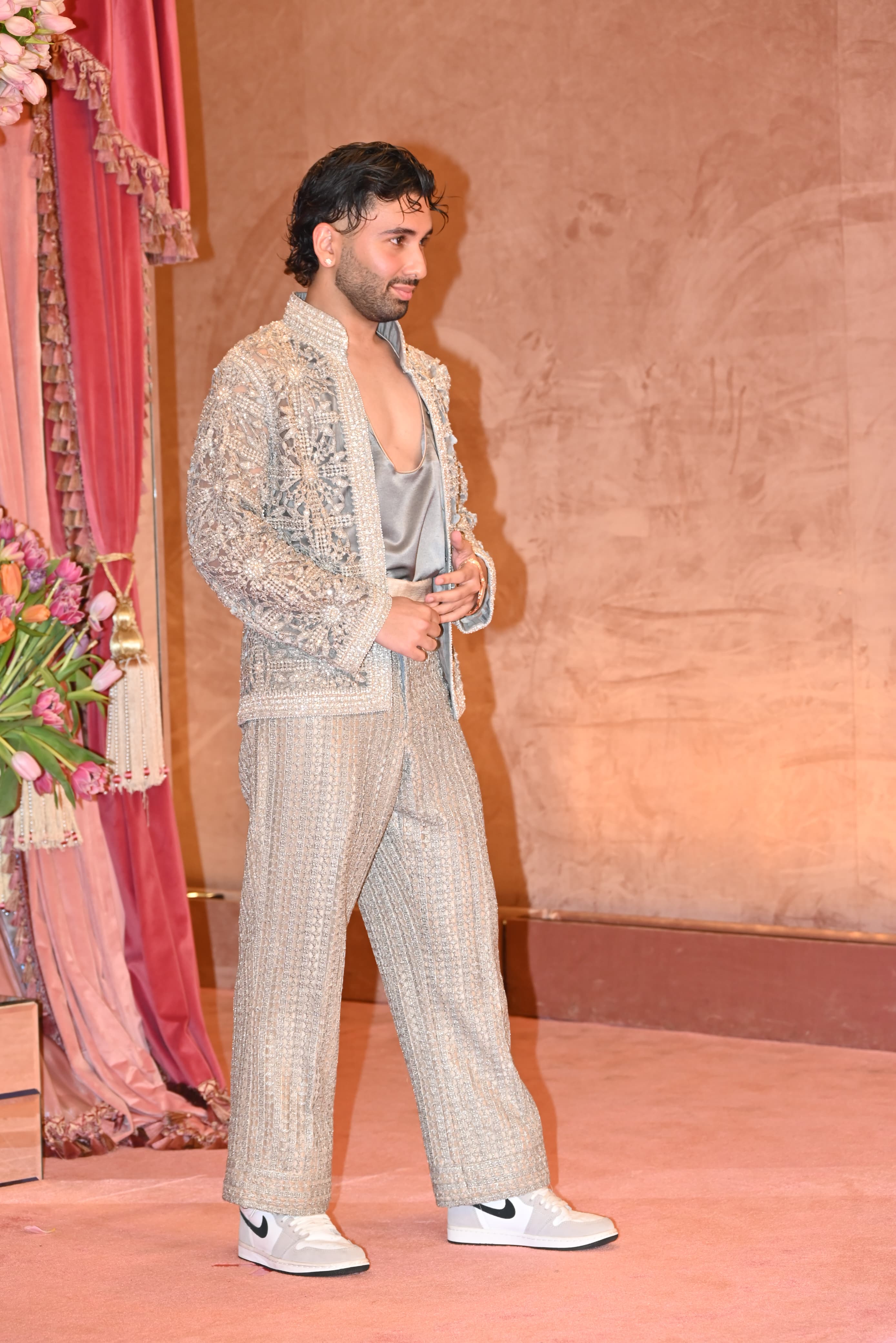 A close friend of Radhika, Orry, was seen posing for the paparazzi. Don't miss the pairing of sneakers with his silver indo-western look!