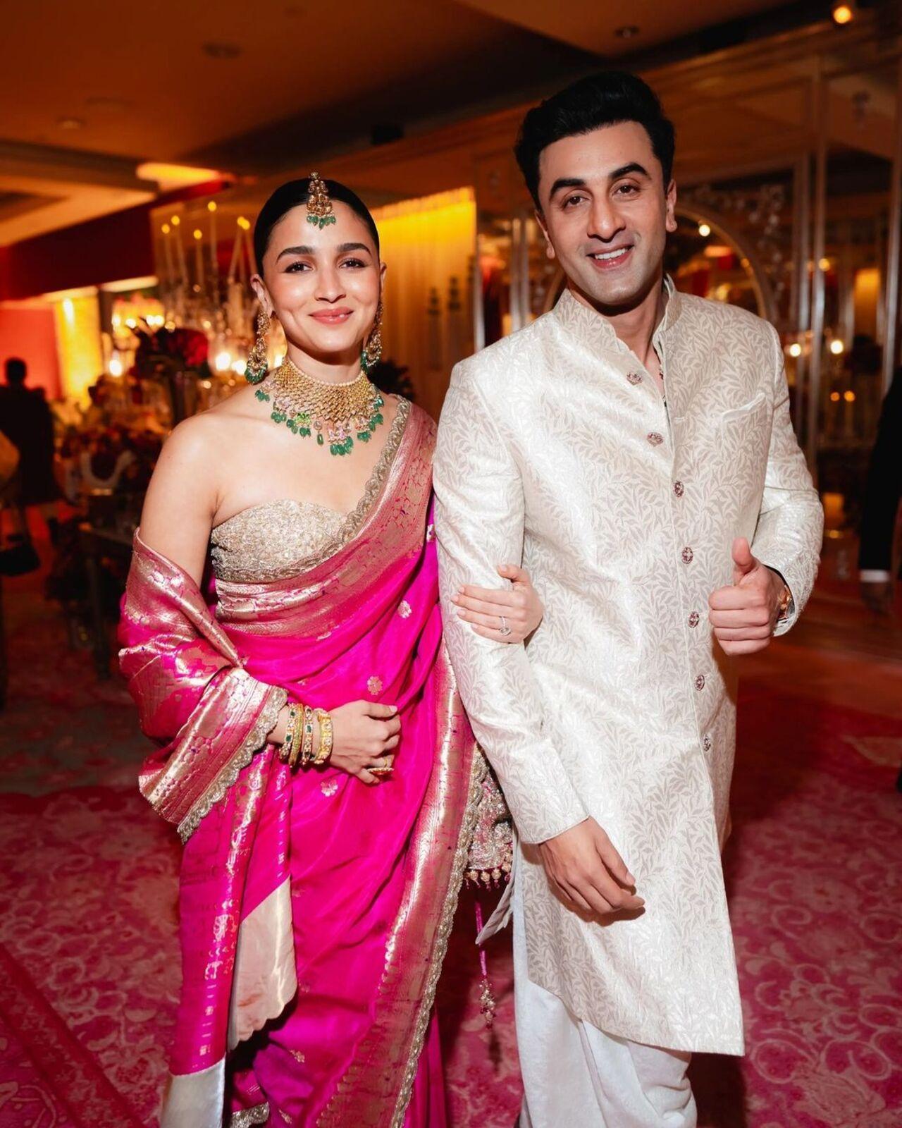 Bollywood couple Ranbir Kapoor and Alia Bhatt graced the wedding ceremony in traditional outfits. Alia opted for a pink coloured sari. She completed her look with a maang tika, jhumka, and a stunning neckpiece. Ranbir chose to wear a sherwani for the occasion. Alia was seen holding Ranbir's hand as they posed for the camera with a smile.