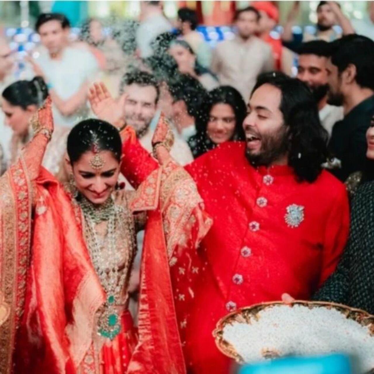 Radhika opted for a striking sindoori red ensemble designed by Manish Malhotra for her emotional Vidai. The picture shows her throwing puffed rice as a part of the ritual. 