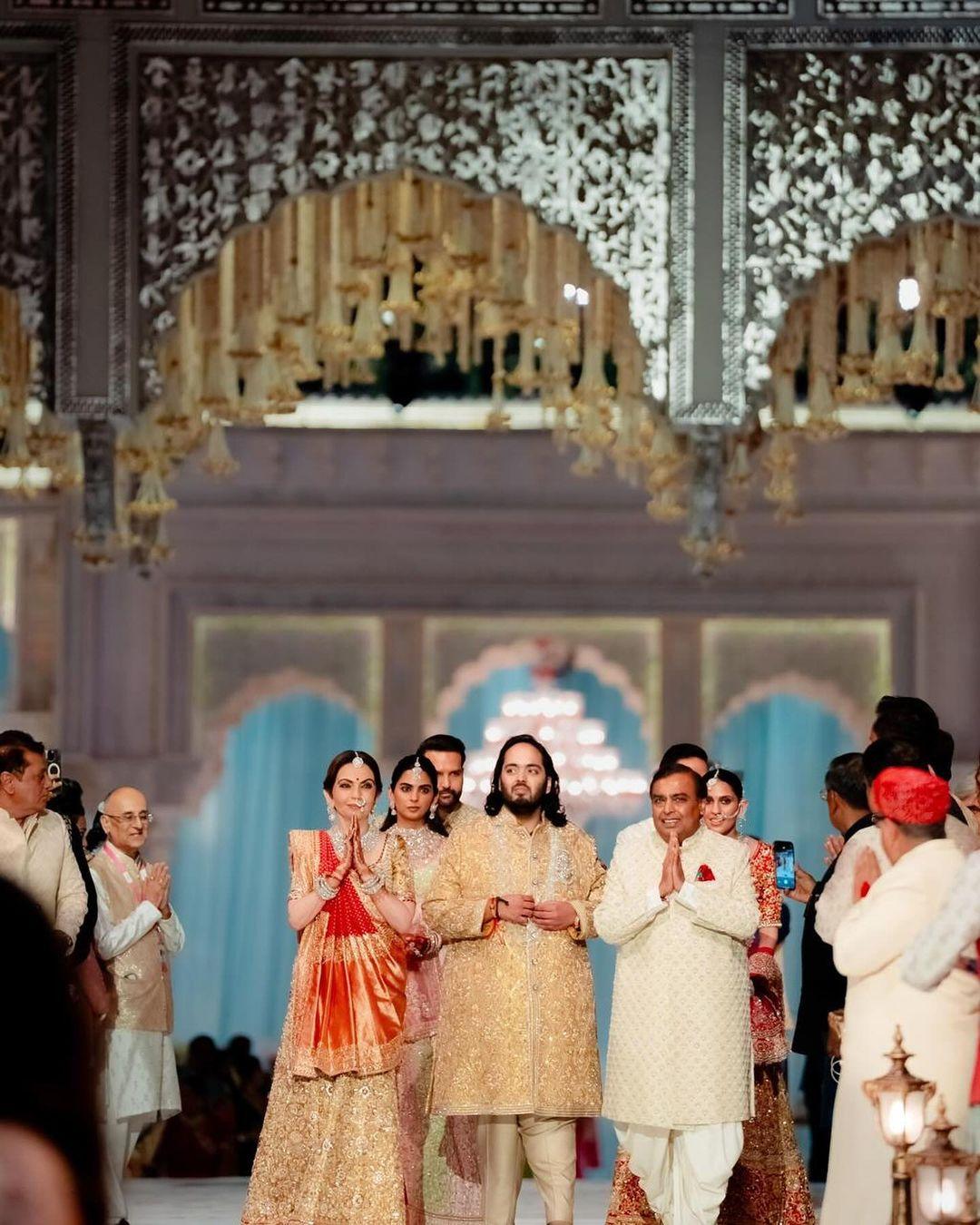 Anant Ambani with his parents at his wedding ceremony