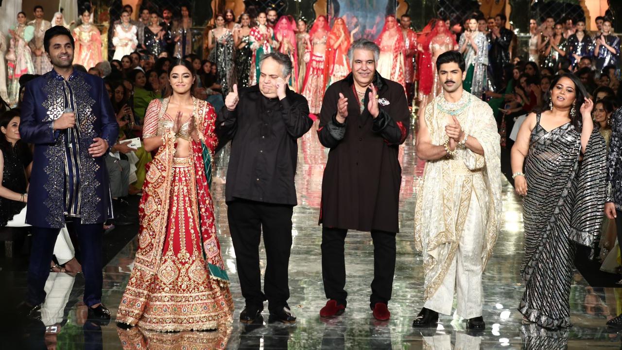 They closed the show with different looks. Wamiqa transformed into a regal bride in a Red Lehenga from the ‘Bridal Gota’ collection, handcrafted with Gota, Zardozi, and encrusted with crystals. Taha was opulence personified in a brocade pant with a dramatic textile drape adorned in Zardozi embroidery. His ensemble was finished with a matching Zardozi belt.