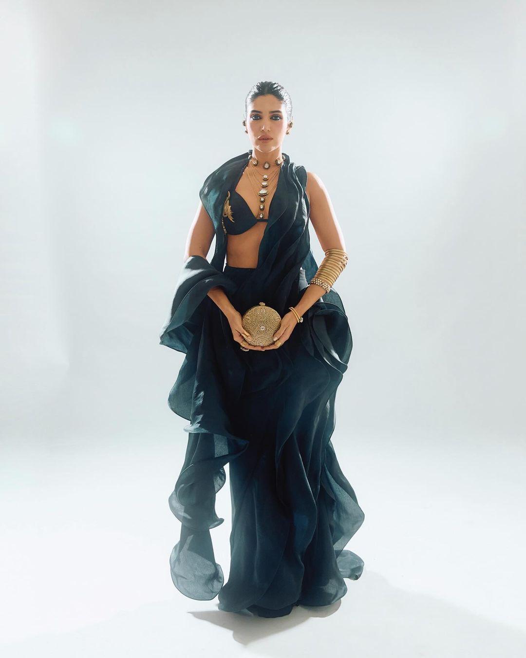 Styled by Chandini Whabi and Simran Mistry, Bhumi paired her outfit with a jeweled clutch from Malaga.