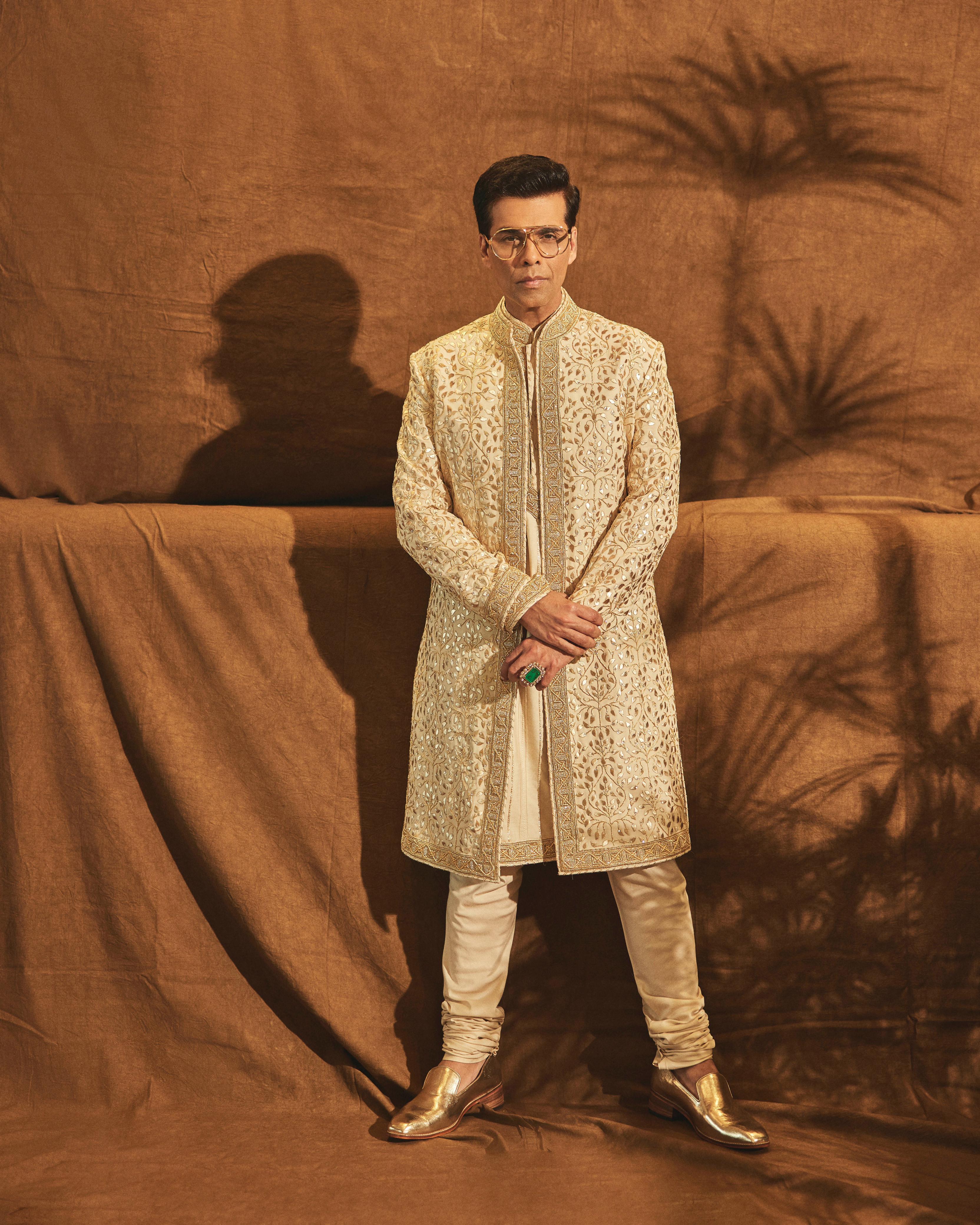 Karan Johar arrives in a gold and silver vasli Sherwani for Anant and Radhika’s wedding ceremony.