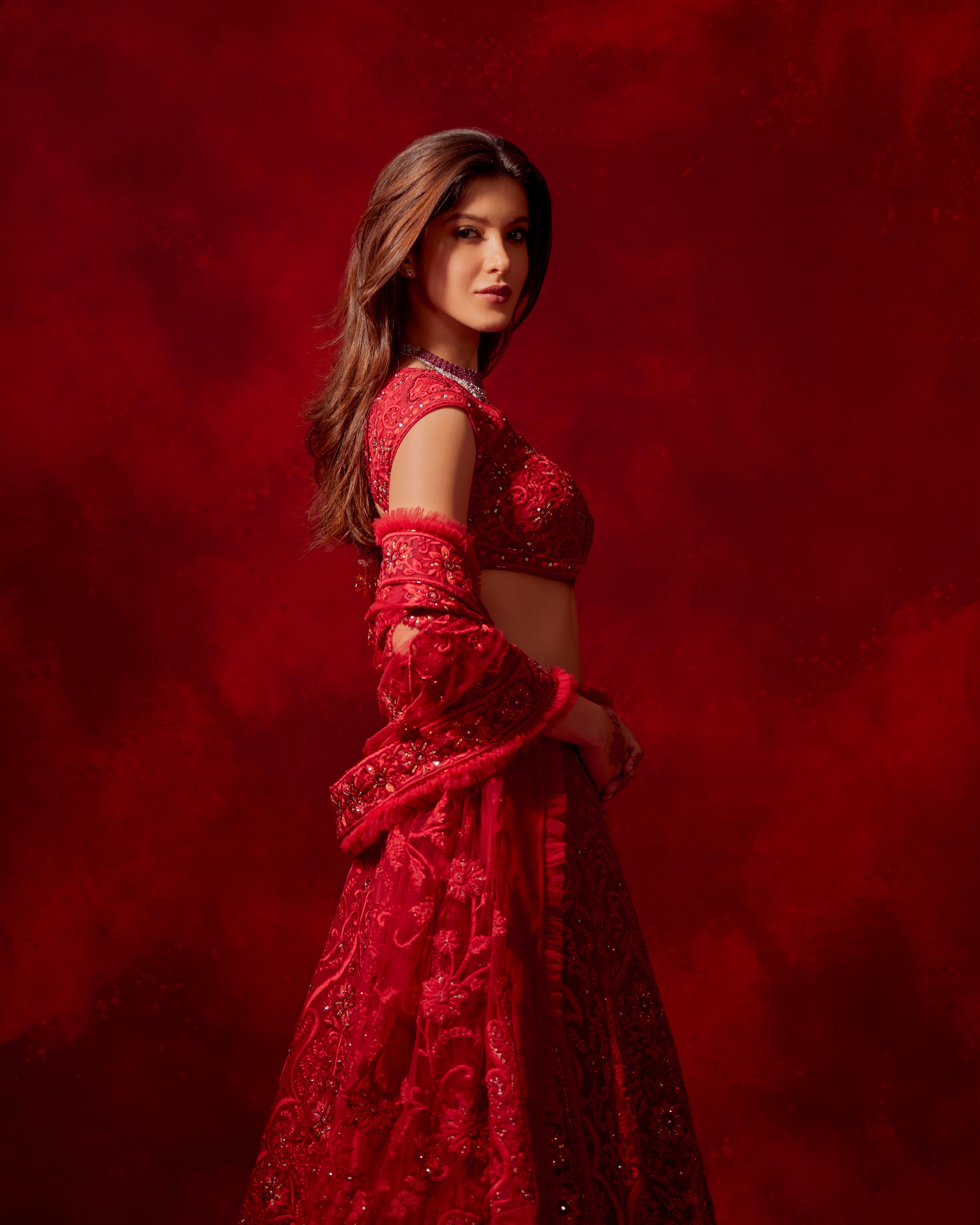 Her ensemble displays the romance of red on red through the delicate workmanship of Resham hand-embroidery infused with matching bugle beads, stones and sequins.