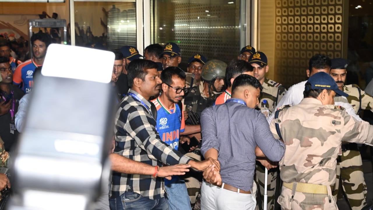 Yuzvendra Chahal being escorted out of the airport by CISF personnel