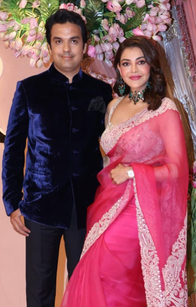 Kajal Aggarwal was the prettiest in a pink saree while her husband Gautam Kitchlu kept it classy in a blue velvet bandhgala. 