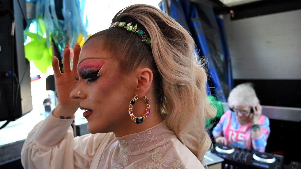 With huge headphones propped over her white hair, Polish DJ and activist Wirginia Szmyt, 85, grooves alongside a drag queen on a float at the Warsaw pride parade