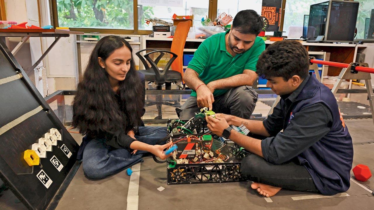 Gaurav Berwal (in green) runs final checks on a robot. Pic/Ashish Raje