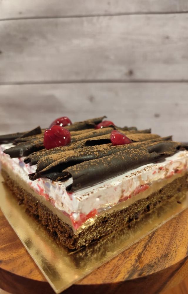 Indulge in the wholesome goodness of cakes featuring a rich chocolate sponge complemented by luxurious layers of dark chocolate mousse and cherry mousse