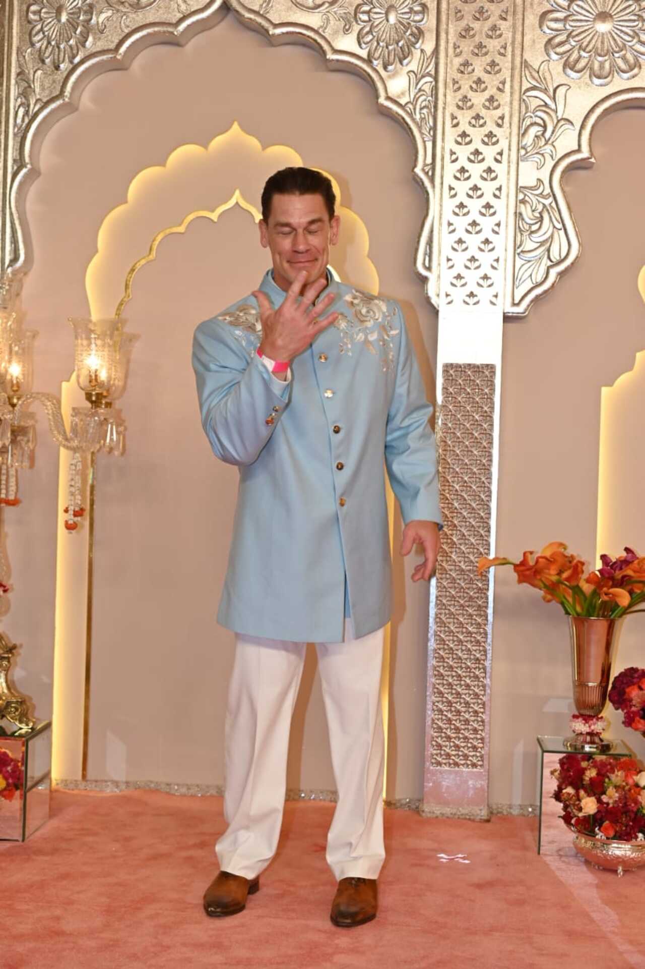 John Cena does his iconic 'Now you can't see me' pose for the media