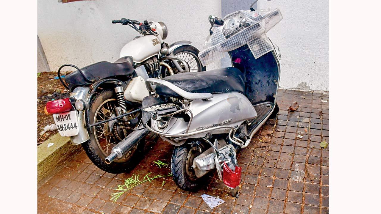 The damaged two-wheeler (right) that the victim was allegedly on when the accident happened. Pics/PTI