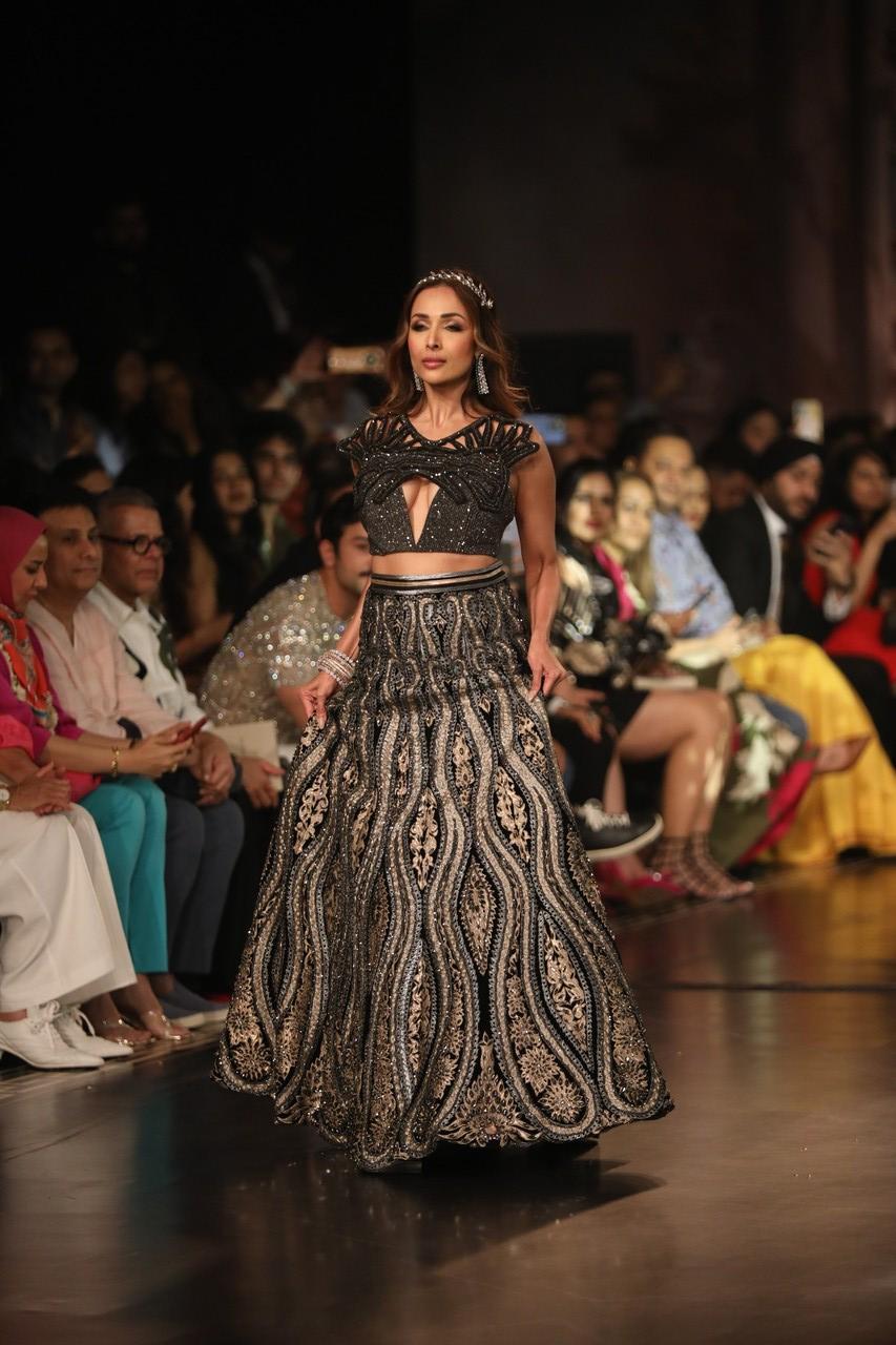 Showstopper Malaika Arora upped the hotness quotient in a black and golden glittering lehenga as sashayed as the showstopper. 